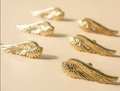 Small shiny gold or silver angel wing cabinet pull/Feathered wing drawer handle/Shiny furniture hardware/small bird wing shaped door knob
