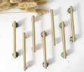 Silky matte gold brass bar handle resting on semi precious stone balls/colourful cabinet handle/stone furniture hardware/crystal drawer pull