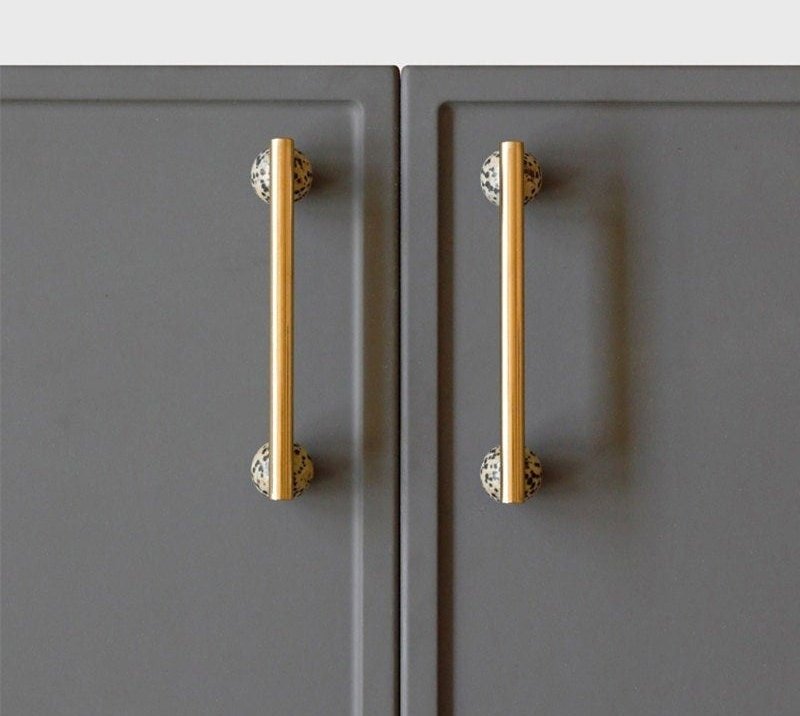 Shiny gold brass bar handle resting on semi precious stone balls/colourful cabinet handle/stone furniture hardware/crystal drawer pull