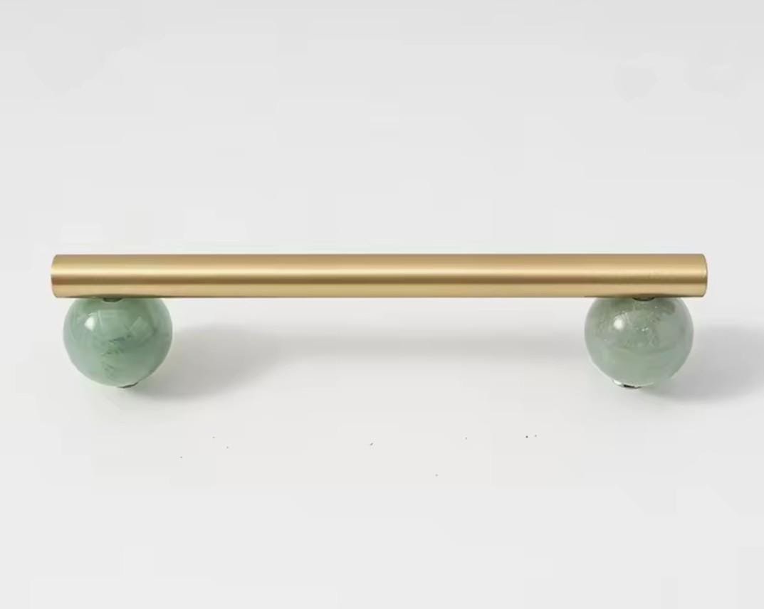 Silky matte gold brass bar handle resting on semi precious stone balls/colourful cabinet handle/stone furniture hardware/crystal drawer pull